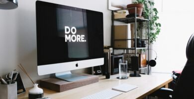 silver iMac with keyboard and trackpad inside room